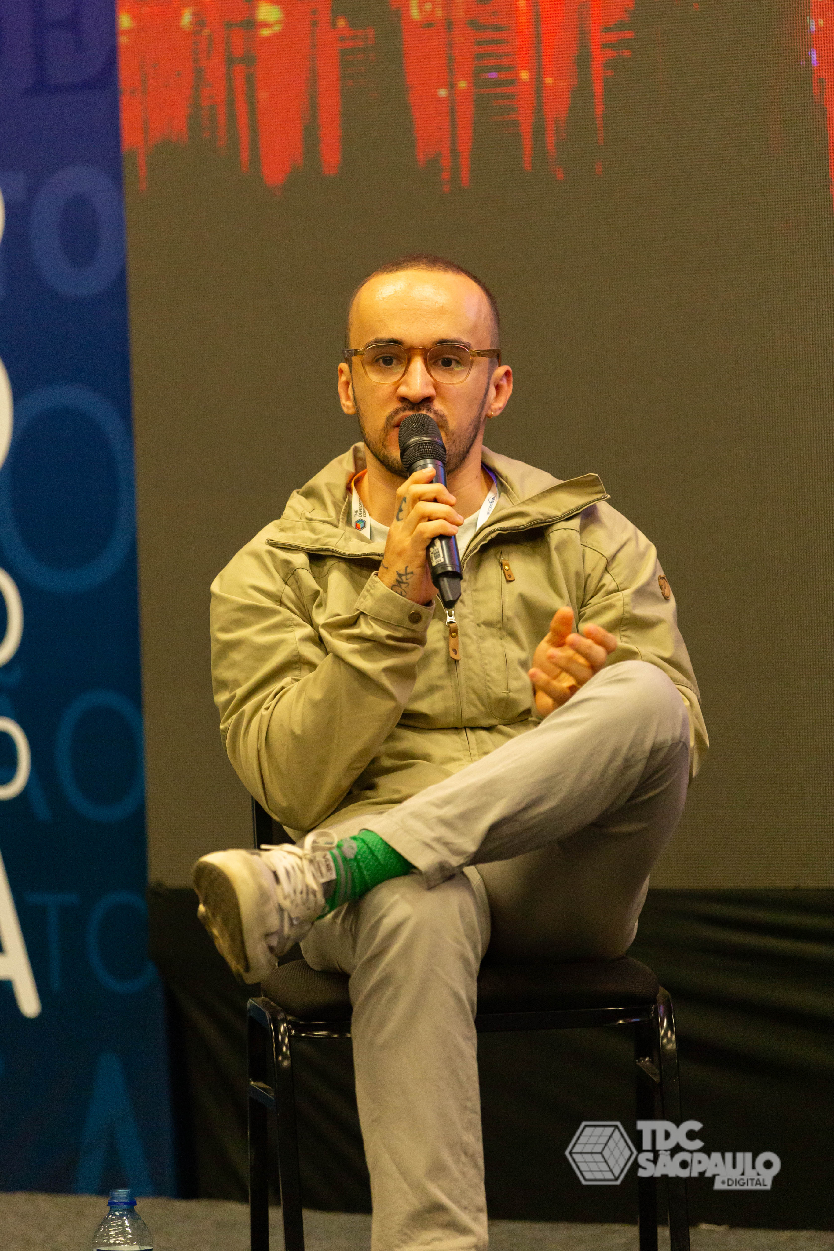 two people sitting on a ledge talking